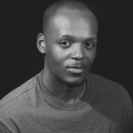 Black and white headshot for Asante Williams. Black male with very short hair.
