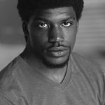 Black and white headshot for Jonathan McCullum. Black male with short hair and a mustache.