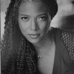 Black and white headshot for Le Titia Sloan. African American female with long hair.