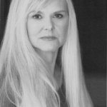 Black and white headshot for Tracey Egan. White female with long blonde hair.