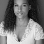 Black and white headshot for Tayla Porter. African American female with long dark hair.